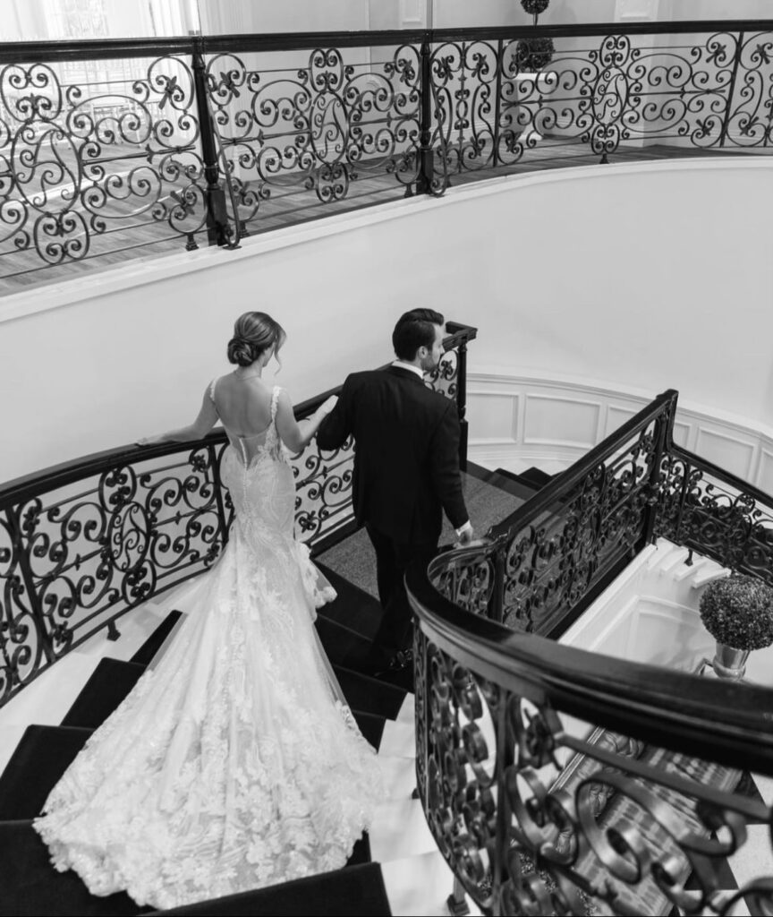 Bride and Groom walking down steps the lobby The Addison Park